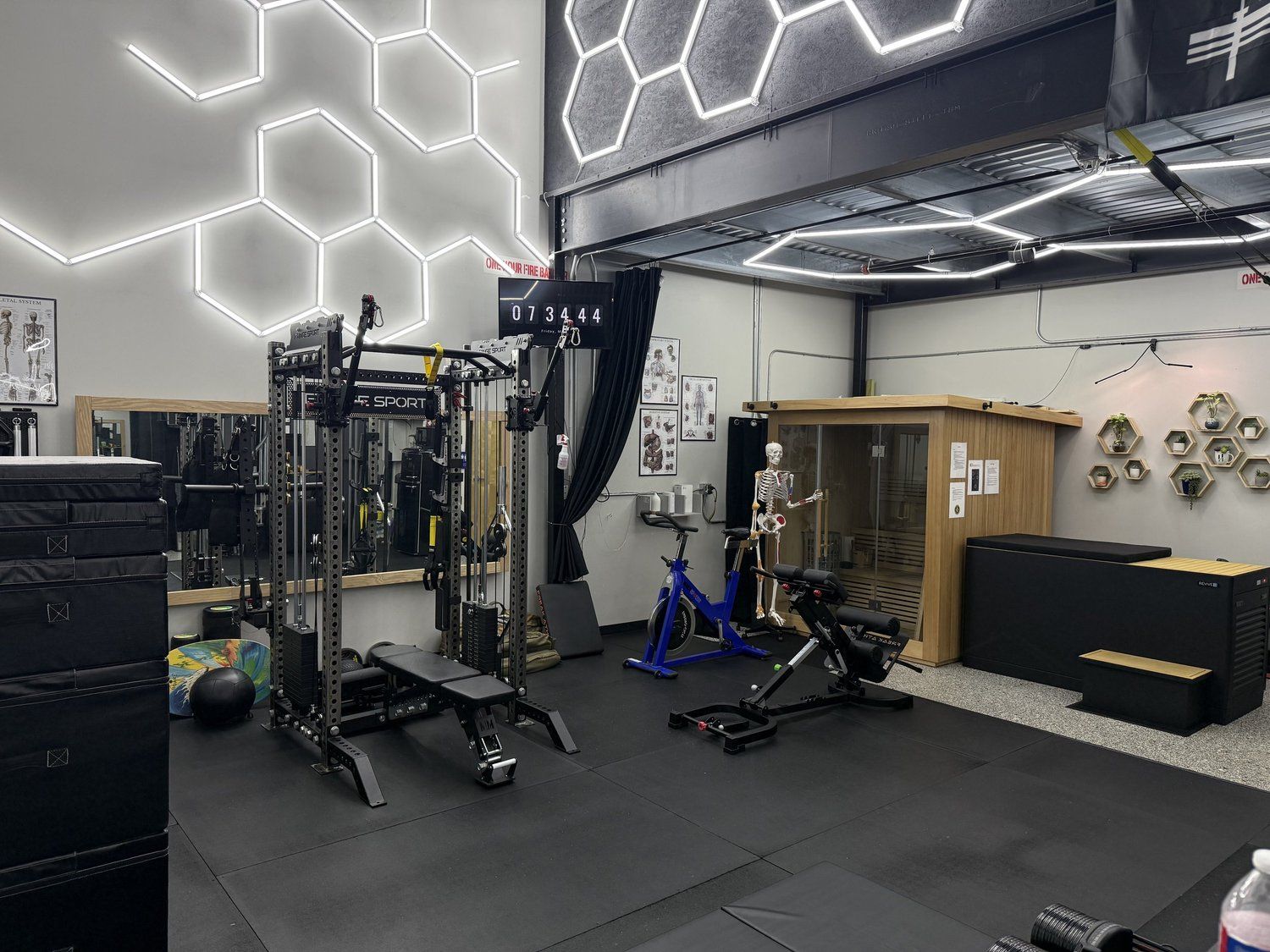 Inside the Complete Health & Wellness private studio, lit by hexagon ceiling lights