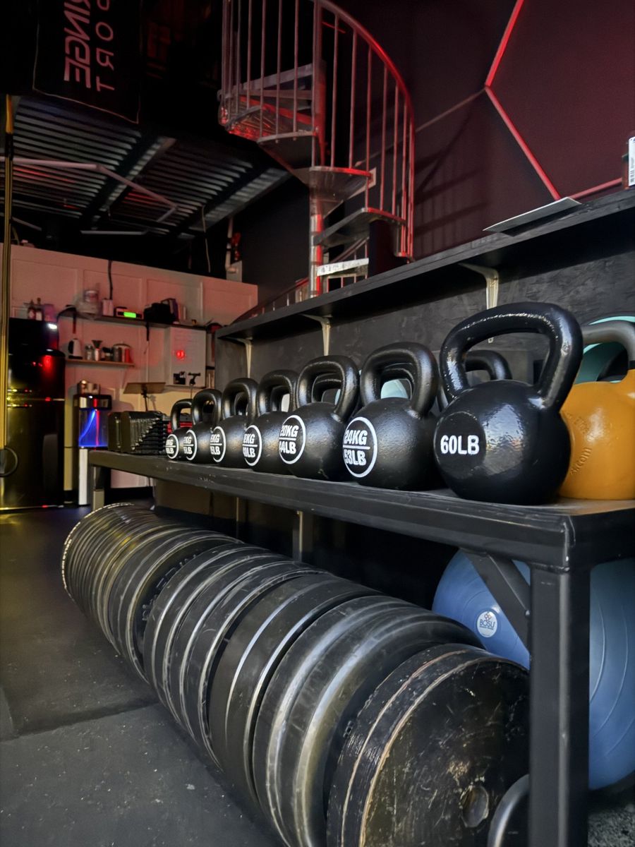 Rack of kettlebells and bumper plates in the studio